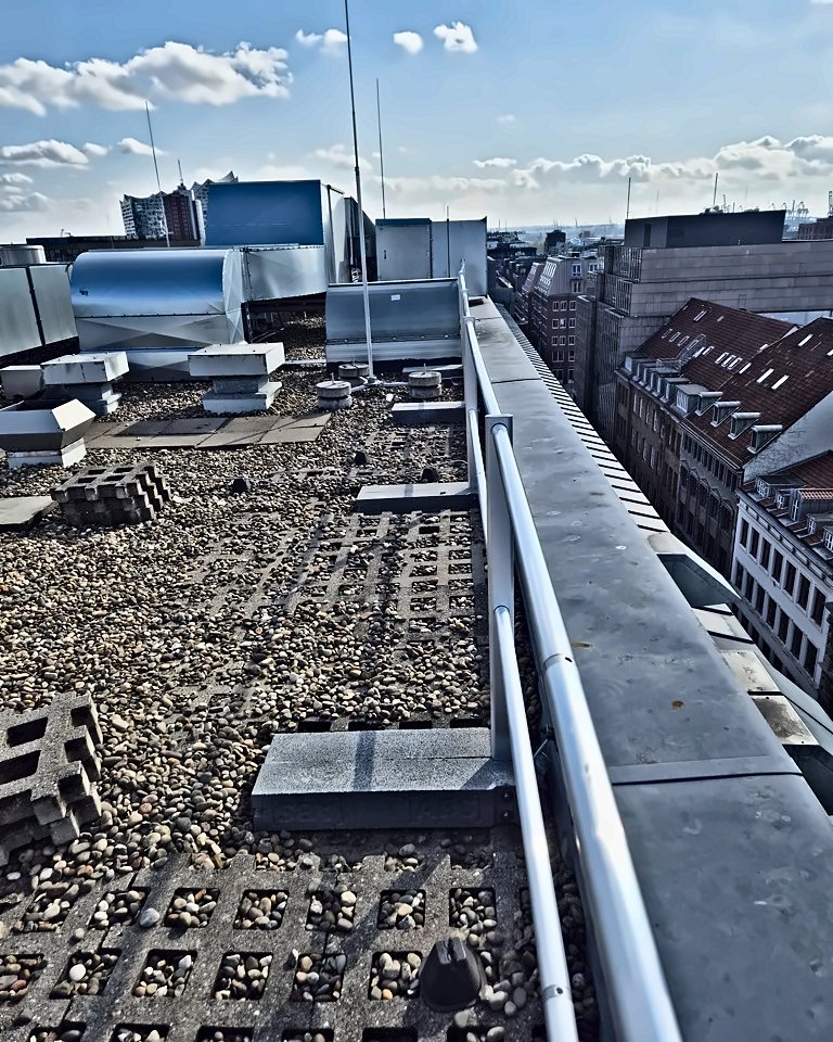Freistehendes Geländer am Rand eines Kiesdachs, Hamburg